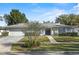 Charming single-story home with a manicured front yard and a paved walkway to the front door at 4913 E Wind St, Orlando, FL 32812