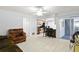 Open-concept living room featuring tile flooring and a view into the kitchen at 4913 E Wind St, Orlando, FL 32812
