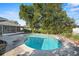 Backyard pool surrounded by lush landscaping at 4913 E Wind St, Orlando, FL 32812