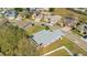 Aerial view showcases the property alongside neighborhood streets, homes and mature tree landscape at 511 Coventry Rd, Davenport, FL 33897