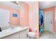 Bathroom with single sink, bright pink walls, and shower at 511 Coventry Rd, Davenport, FL 33897