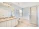Bathroom with double sinks, bathtub, stand up shower, and blue walls at 511 Coventry Rd, Davenport, FL 33897
