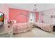 Cute pink bedroom with two carriage beds and a decorative chandelier at 511 Coventry Rd, Davenport, FL 33897