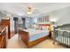 Serene bedroom featuring a wooden bed frame, a ceiling fan, and soft blue accents at 511 Coventry Rd, Davenport, FL 33897