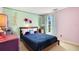 Decorated bedroom with purple and mint accents, jellyfish chandelier, and dark blue bedding at 511 Coventry Rd, Davenport, FL 33897