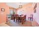 Traditional dining room with wood table and chairs, plus modern light fixture and unique wall decorations at 511 Coventry Rd, Davenport, FL 33897