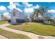 Charming two-story home with a well-manicured lawn and lush landscaping at 511 Coventry Rd, Davenport, FL 33897