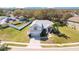 Inviting single-story home with a manicured front lawn, attached garage, and a red front door at 511 Coventry Rd, Davenport, FL 33897