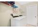 Laundry room with side-by-side washer and dryer and storage shelves at 511 Coventry Rd, Davenport, FL 33897