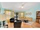 Bright living room with yellow sofa and sliding glass doors to the pool at 511 Coventry Rd, Davenport, FL 33897