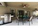 Outdoor patio with a stainless steel grill, dining table, and ceiling fans at 511 Coventry Rd, Davenport, FL 33897