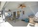 Covered patio with ceiling fans, grilling area, and a table with chairs at 511 Coventry Rd, Davenport, FL 33897