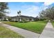 Beautiful single story home features a well-manicured lawn and mature trees at 604 Darcey Dr, Winter Park, FL 32792