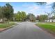 Neighborhood street view with mature trees, sidewalks, and well-maintained lawns at 604 Darcey Dr, Winter Park, FL 32792