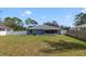 Enjoy this large backyard with a full fence, lawn and view of the home at 607 S Glencoe Rd, New Smyrna Beach, FL 32168