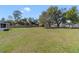 Enjoy this large backyard with a full fence, lawn and mature trees at 607 S Glencoe Rd, New Smyrna Beach, FL 32168