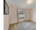 This carpeted bedroom features a window with curtain and neutral paint colors at 607 S Glencoe Rd, New Smyrna Beach, FL 32168