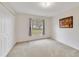 This bedroom features carpeted floors, a double door closet, and a window at 607 S Glencoe Rd, New Smyrna Beach, FL 32168