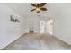Neutral bedroom with a ceiling fan, leading to ensuite bathroom at 607 S Glencoe Rd, New Smyrna Beach, FL 32168