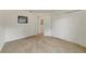 This carpeted bedroom features a door to another room and a double door closet at 607 S Glencoe Rd, New Smyrna Beach, FL 32168