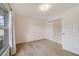 This carpeted bedroom features a window with curtain and a double door closet at 607 S Glencoe Rd, New Smyrna Beach, FL 32168