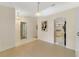 Dining area with neutral walls, wood-look flooring, and an arched entry to the kitchen at 607 S Glencoe Rd, New Smyrna Beach, FL 32168