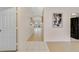 Hallway with neutral walls, wood-look floors and a white door and views to the backyard at 607 S Glencoe Rd, New Smyrna Beach, FL 32168