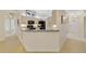 Bright kitchen with breakfast bar, seamlessly connects to the entryway at 607 S Glencoe Rd, New Smyrna Beach, FL 32168