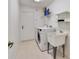 Functional laundry room features a washer, dryer, and utility sink at 607 S Glencoe Rd, New Smyrna Beach, FL 32168