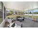 Relax in this screened-in porch, complete with modern furniture and view of backyard at 607 S Glencoe Rd, New Smyrna Beach, FL 32168