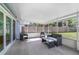 Relax in this screened-in porch, complete with modern furniture and view of backyard at 607 S Glencoe Rd, New Smyrna Beach, FL 32168