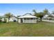 Back view of single-story house with fenced-in porch and green lawn at 624 Illinois Ave, St Cloud, FL 34769