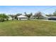 Spacious backyard with a well-manicured lawn and mature trees, offering ample space at 624 Illinois Ave, St Cloud, FL 34769