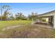 Large, open backyard with a covered carport and ample green space at 624 Illinois Ave, St Cloud, FL 34769