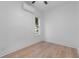 Bedroom featuring light wood flooring, white walls, a window and an air conditioning unit at 624 Illinois Ave, St Cloud, FL 34769