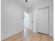Bedroom with light wood flooring, white walls, closet, and doorway with a view of the front door at 624 Illinois Ave, St Cloud, FL 34769