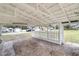 Covered carport area with white picket fence and gravel ground at 624 Illinois Ave, St Cloud, FL 34769
