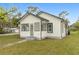 Charming home with white siding, black trim, and a well-maintained front lawn at 624 Illinois Ave, St Cloud, FL 34769
