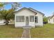 Charming single-story home with white siding, black trim, and a well-maintained lawn at 624 Illinois Ave, St Cloud, FL 34769