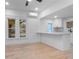 Bright white kitchen with stainless steel appliances, quartz countertops, modern lighting and wood-look flooring at 624 Illinois Ave, St Cloud, FL 34769
