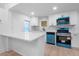Modern kitchen with sleek white cabinets, new stainless steel appliances, and bright countertops at 624 Illinois Ave, St Cloud, FL 34769