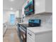 Stylish kitchen featuring white cabinets, countertops, and brand-new stainless steel appliances at 624 Illinois Ave, St Cloud, FL 34769