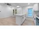 Bright kitchen with white cabinets, quartz countertops, stainless steel sink and modern fixtures at 624 Illinois Ave, St Cloud, FL 34769