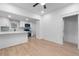 Open-concept living and dining area with hardwood floors and newly remodeled kitchen in the background at 624 Illinois Ave, St Cloud, FL 34769