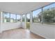 Enclosed sunroom with wood-look floors and multiple windows flooding the space with natural light at 624 Illinois Ave, St Cloud, FL 34769