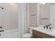 Bathroom with shower-tub combo, hexagon tile accent wall, and modern fixtures at 6920 Dappled Oak Way, Orlando, FL 32829