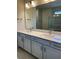 Bathroom featuring double sinks, stylish cabinetry, and a large mirror at 6920 Dappled Oak Way, Orlando, FL 32829