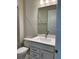 Bathroom features a modern vanity, sink, toilet, and decorative mirror with lighting at 6920 Dappled Oak Way, Orlando, FL 32829