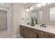 Bathroom featuring double vanity, modern fixtures, and a large mirror at 6920 Dappled Oak Way, Orlando, FL 32829