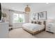 Serene bedroom featuring a large window, wood accents, and neutral decor for a relaxing space at 6920 Dappled Oak Way, Orlando, FL 32829